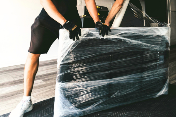 Furniture movers wrapping furniture